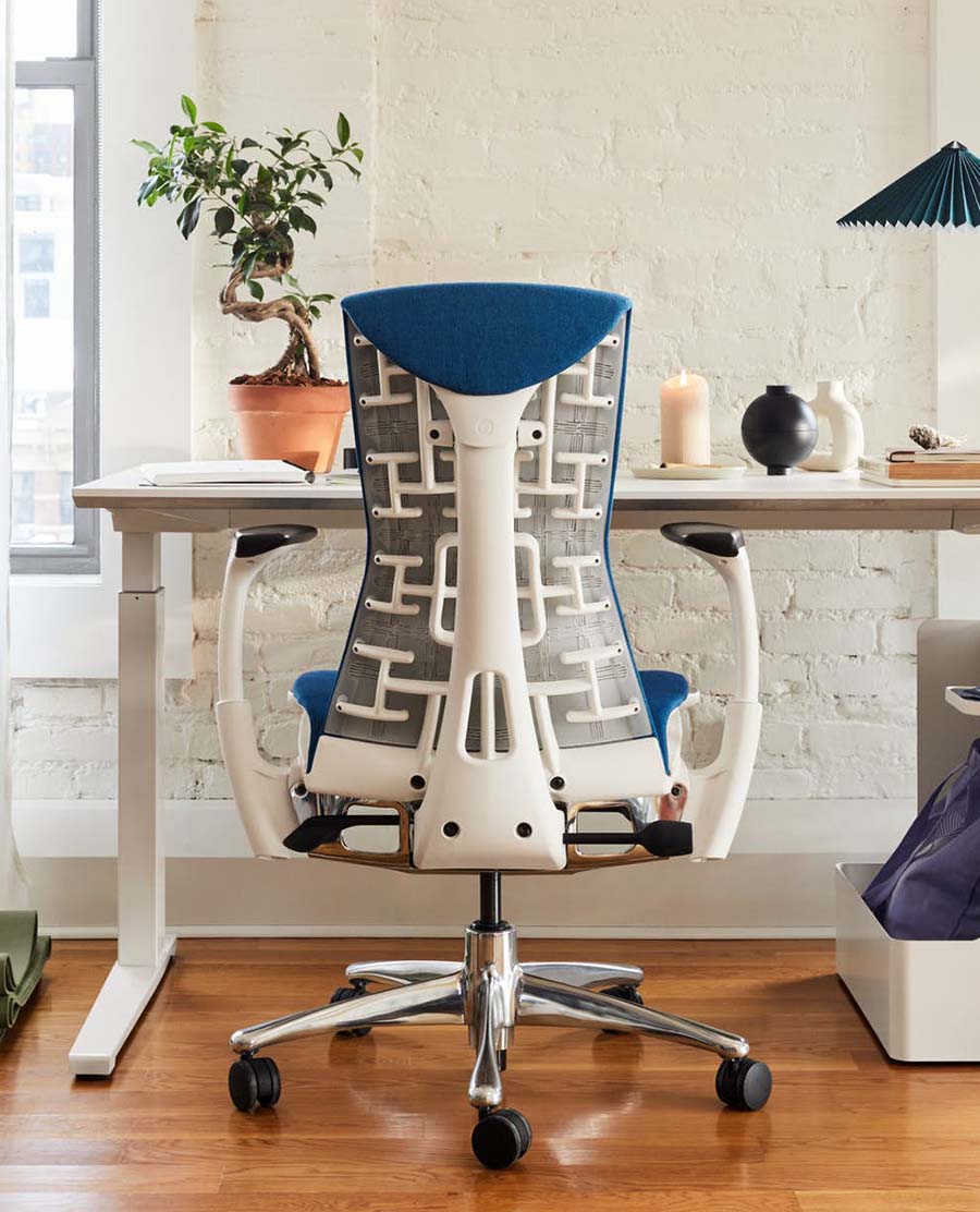 Blue and white task chair at a desk in an office.